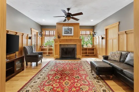 a living room with furniture fireplace and window