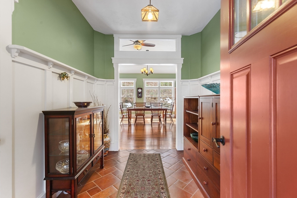 144 Brook Street Hudson, MA 01749 - Photo 8 of 44 a hallway with dining area and chandelier