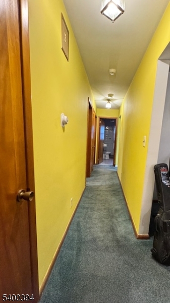 46 Guenther Place Passaic, NJ 07055 - Photo 4 of 10 a view of a hallway with wooden shelves