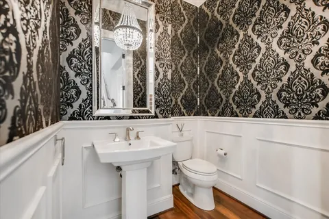 a bathroom with a toilet sink and mirror