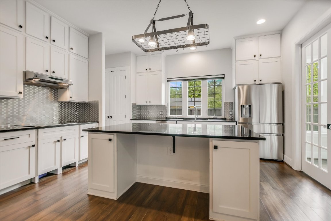 5200 Avenue H Austin, TX 78751 - Photo 14 of 20 a kitchen with stainless steel appliances granite countertop a stove a sink and white cabinets