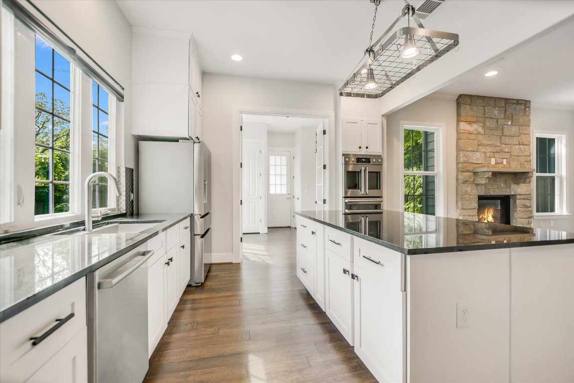 5200 Avenue H Austin, TX 78751 - Photo 15 of 20 a large kitchen with granite countertop a large counter top space a sink stainless steel appliances and cabinets