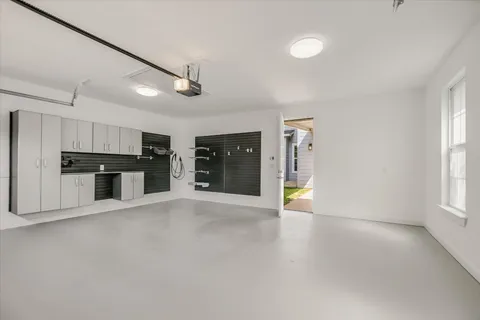 an empty room with windows and pillars in it