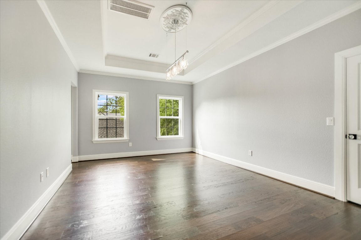5200 Avenue H Austin, TX 78751 - Photo 5 of 20 an empty room with wooden floor chandelier and windows