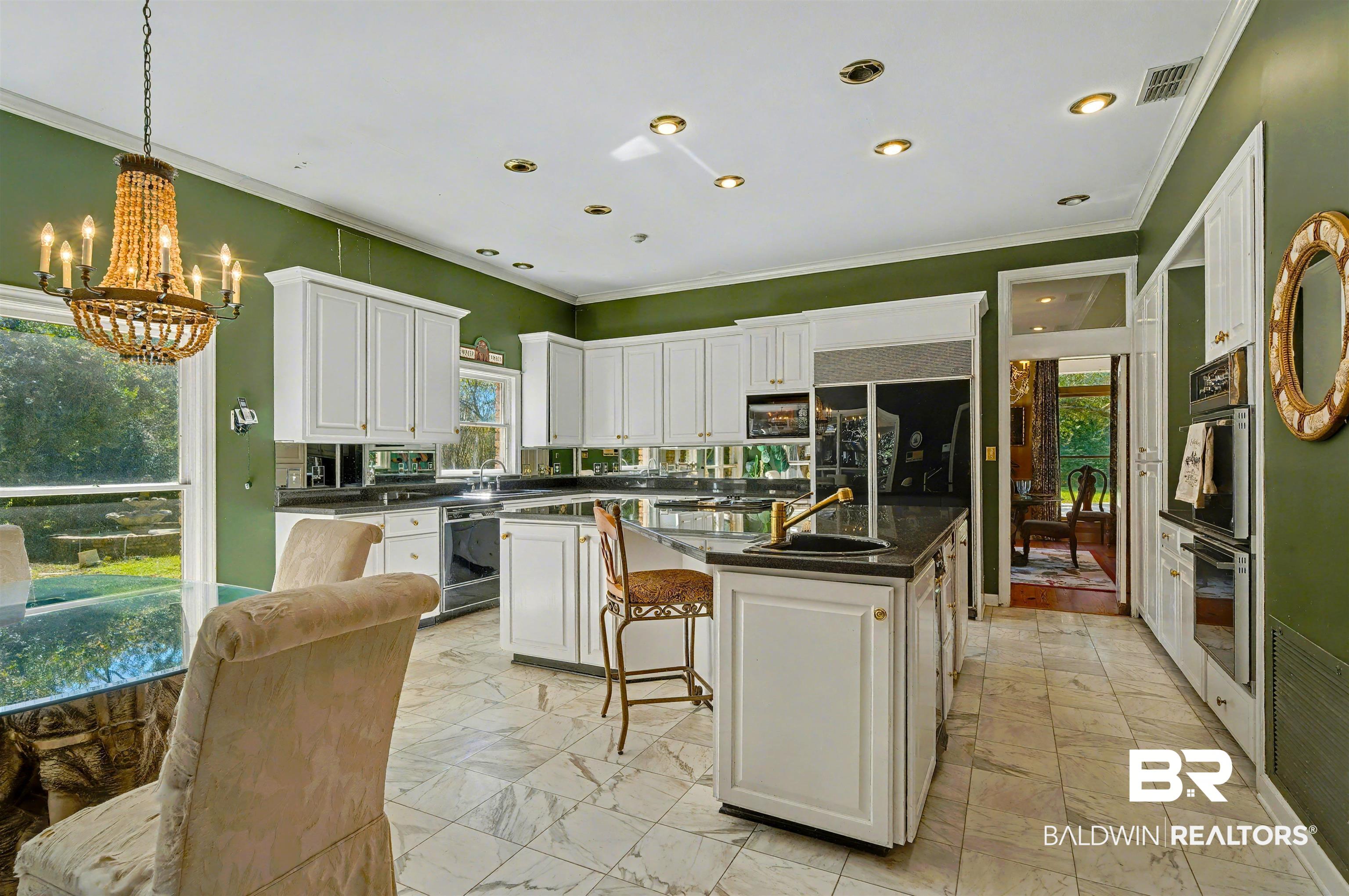 15810 County Road 73 Foley, AL 36535 - Photo 18 of 56 Kitchen with white cabinets, ornamental molding, a breakfast bar, healthy amount of natural light, and recessed lighting