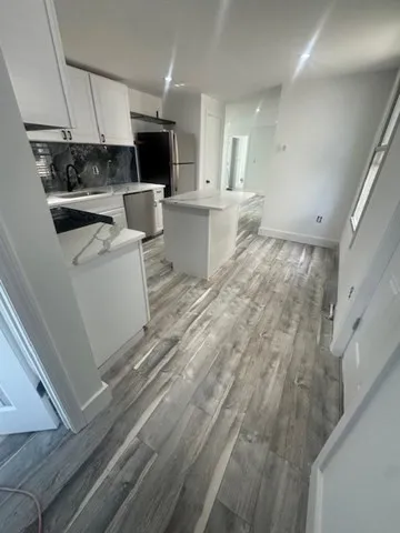 a living room with a couch and a stove top oven