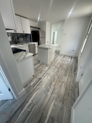 a living room with a couch and a stove top oven