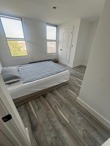 252 East Eagle Street, Unit 2 Boston, MA 02128 - Photo 2 of 11 a bedroom with a bed and a window