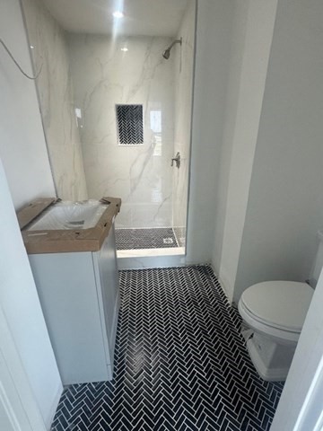 252 East Eagle Street, Unit 2 Boston, MA 02128 - Photo 5 of 11 a bathroom with a sink toilet and shower