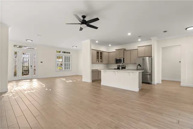 a view of a kitchen with a sink stainless steel appliances and cabinets