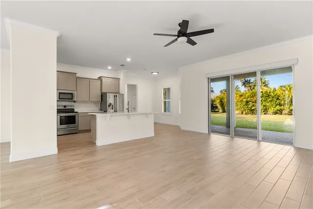a view of kitchen with refrigerator and wooden floor