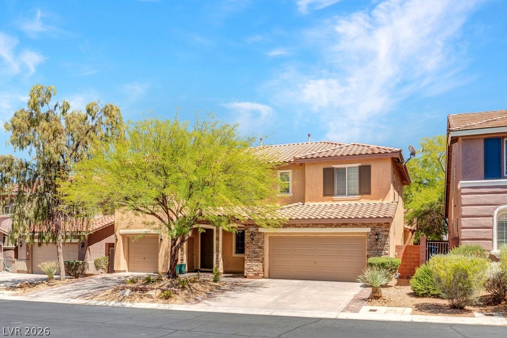 10336 Hawk Ravine Street Las Vegas, NV 89178 - Photo 56 of 59 This residence features a beautiful tile roof and an attached garage.