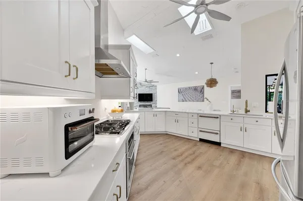 a kitchen with white cabinets and white appliances