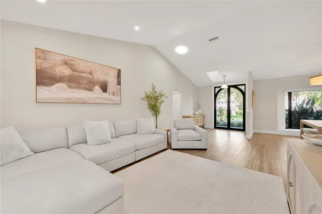 a living room with furniture and wooden floor