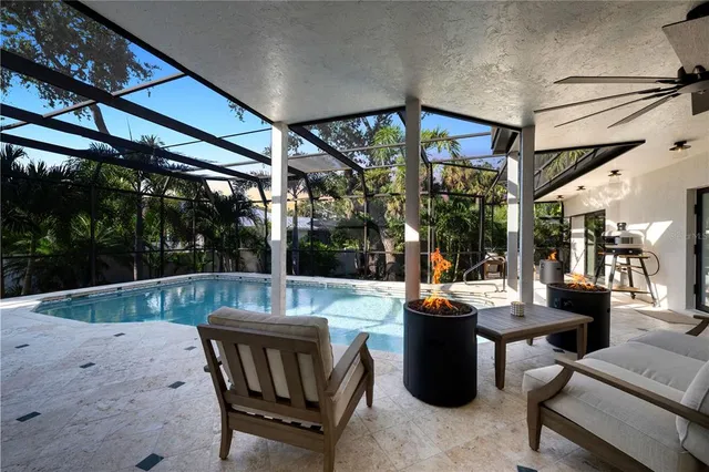 a view of a patio with plants and table and chairs under an umbrella