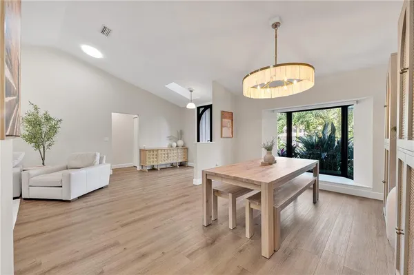 a view of a livingroom with furniture window and wooden floor