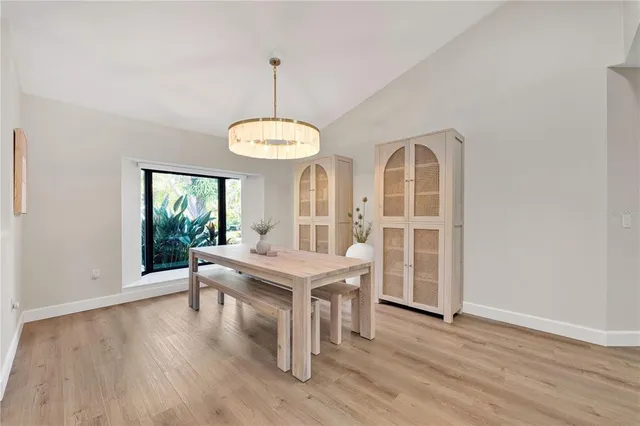 a view of living room with kitchen island furniture and flat screen tv