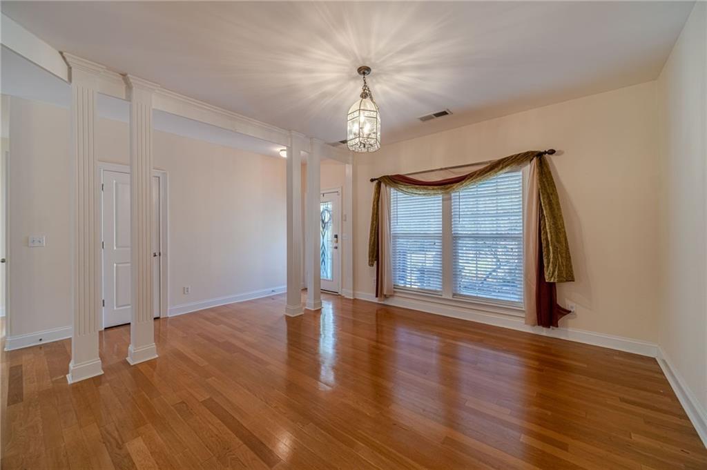 654 Huntington Trace Winder, GA 30680 - Photo 18 of 51 a view of an empty room with wooden floor and a window
