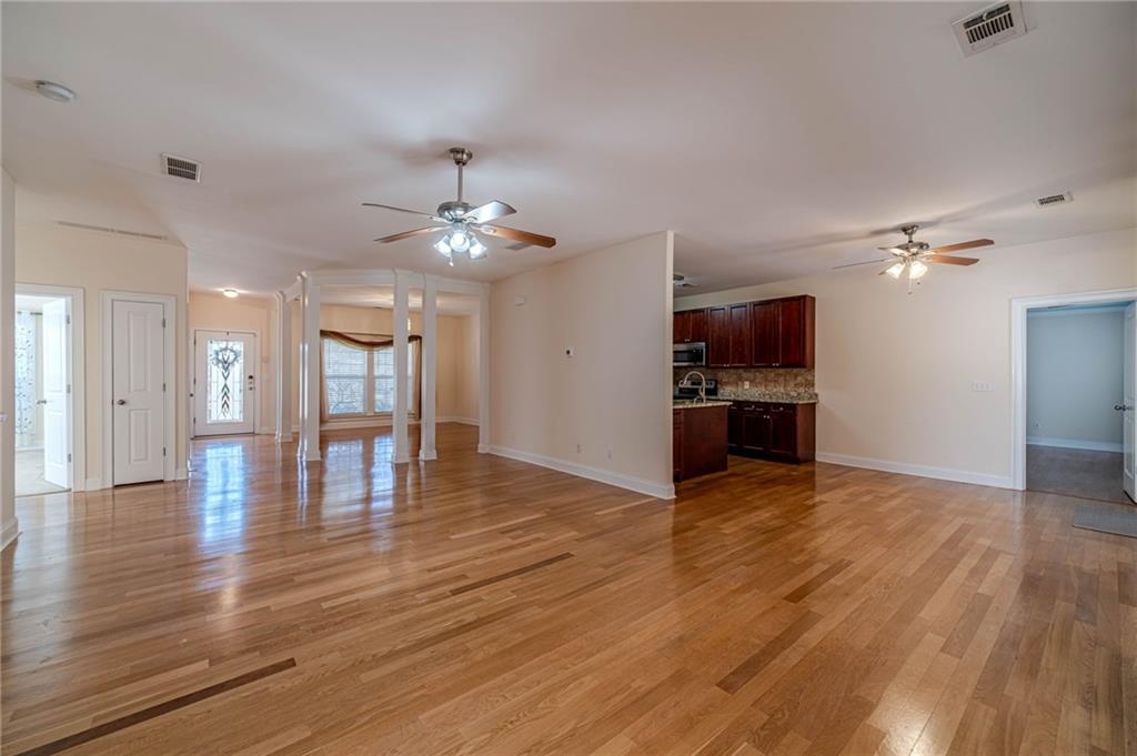 654 Huntington Trace Winder, GA 30680 - Photo 2 of 51 a view of an empty room and kitchen with wooden floor