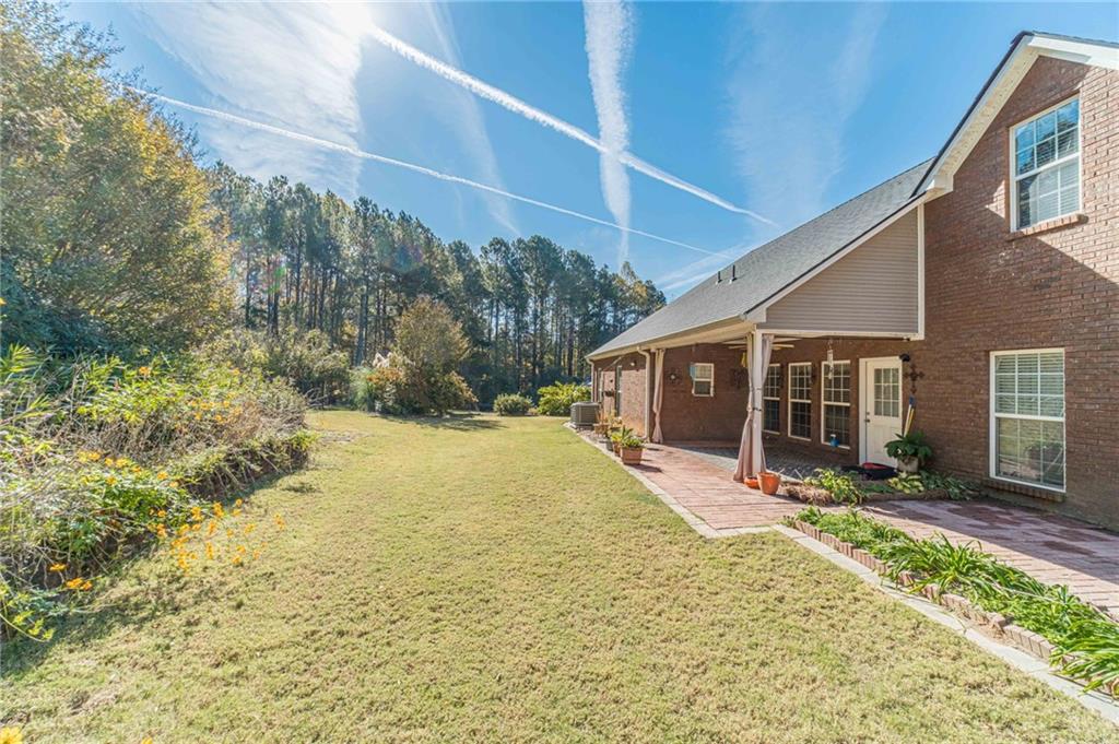654 Huntington Trace Winder, GA 30680 - Photo 31 of 51 a view of a house with a yard