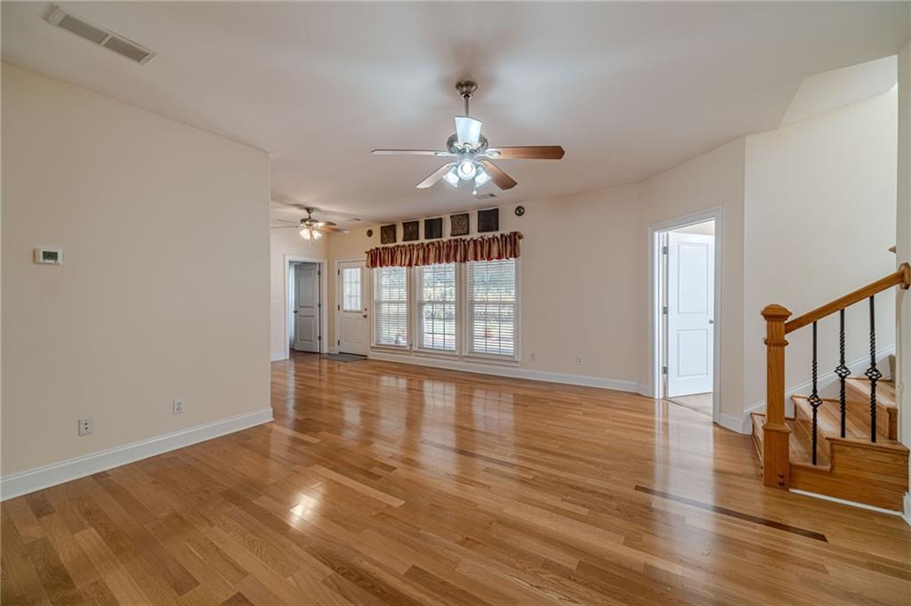 654 Huntington Trace Winder, GA 30680 - Photo 4 of 51 wooden floor in an empty room with a window