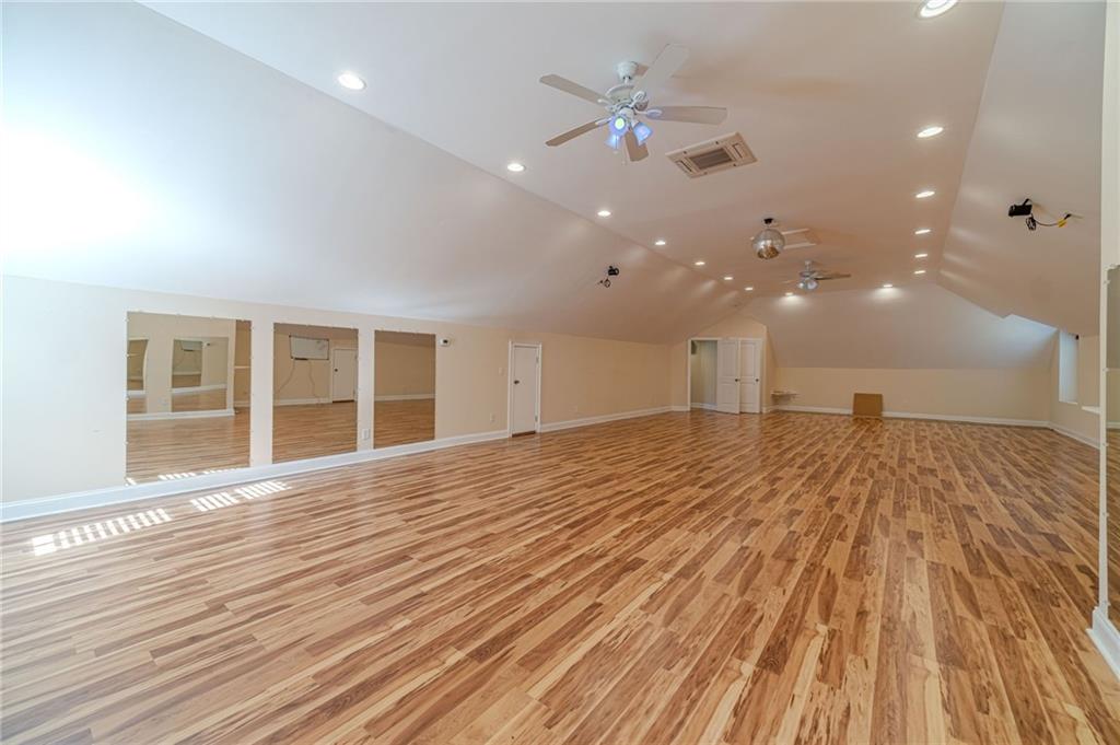 654 Huntington Trace Winder, GA 30680 - Photo 9 of 51 a view of an empty room with wooden floor and a window