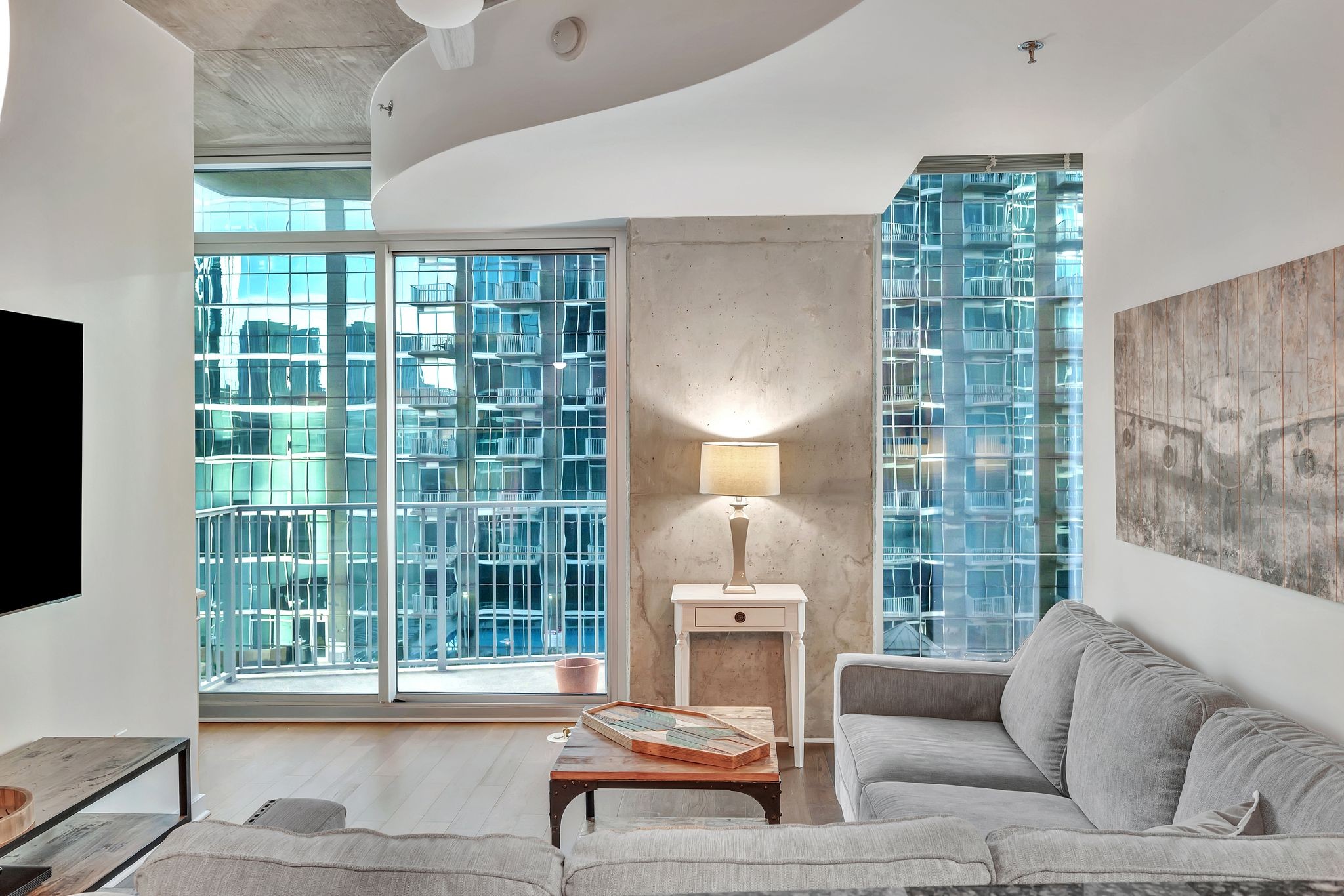 301 Demonbreun Street, Unit 1120 Nashville, TN 37201 - Photo 11 of 51 a living room with furniture and a lamp