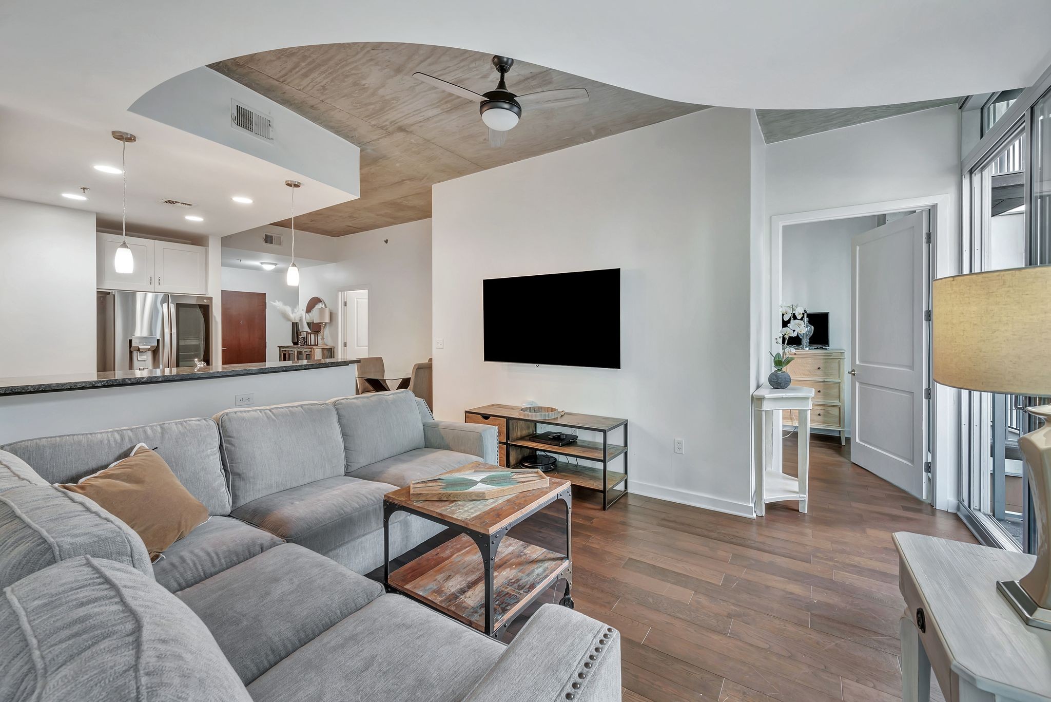 301 Demonbreun Street, Unit 1120 Nashville, TN 37201 - Photo 13 of 51 a living room with furniture and a flat screen tv