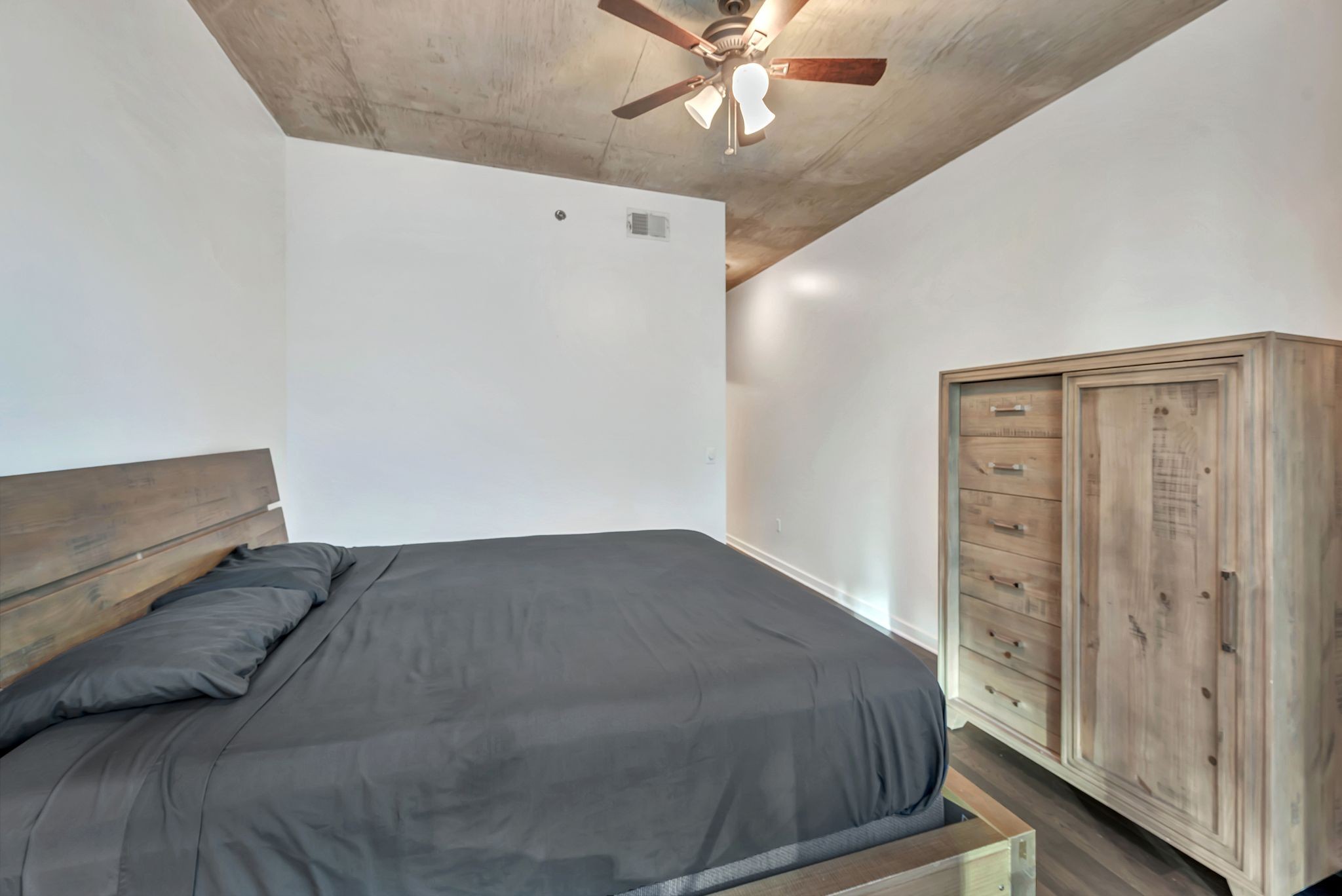 301 Demonbreun Street, Unit 1120 Nashville, TN 37201 - Photo 17 of 51 a bedroom with a bed and a chandelier