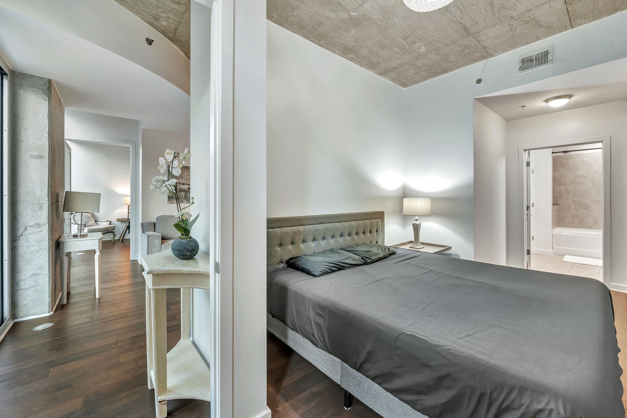 301 Demonbreun Street, Unit 1120 Nashville, TN 37201 - Photo 24 of 51 a bedroom with a bed and a view of living room