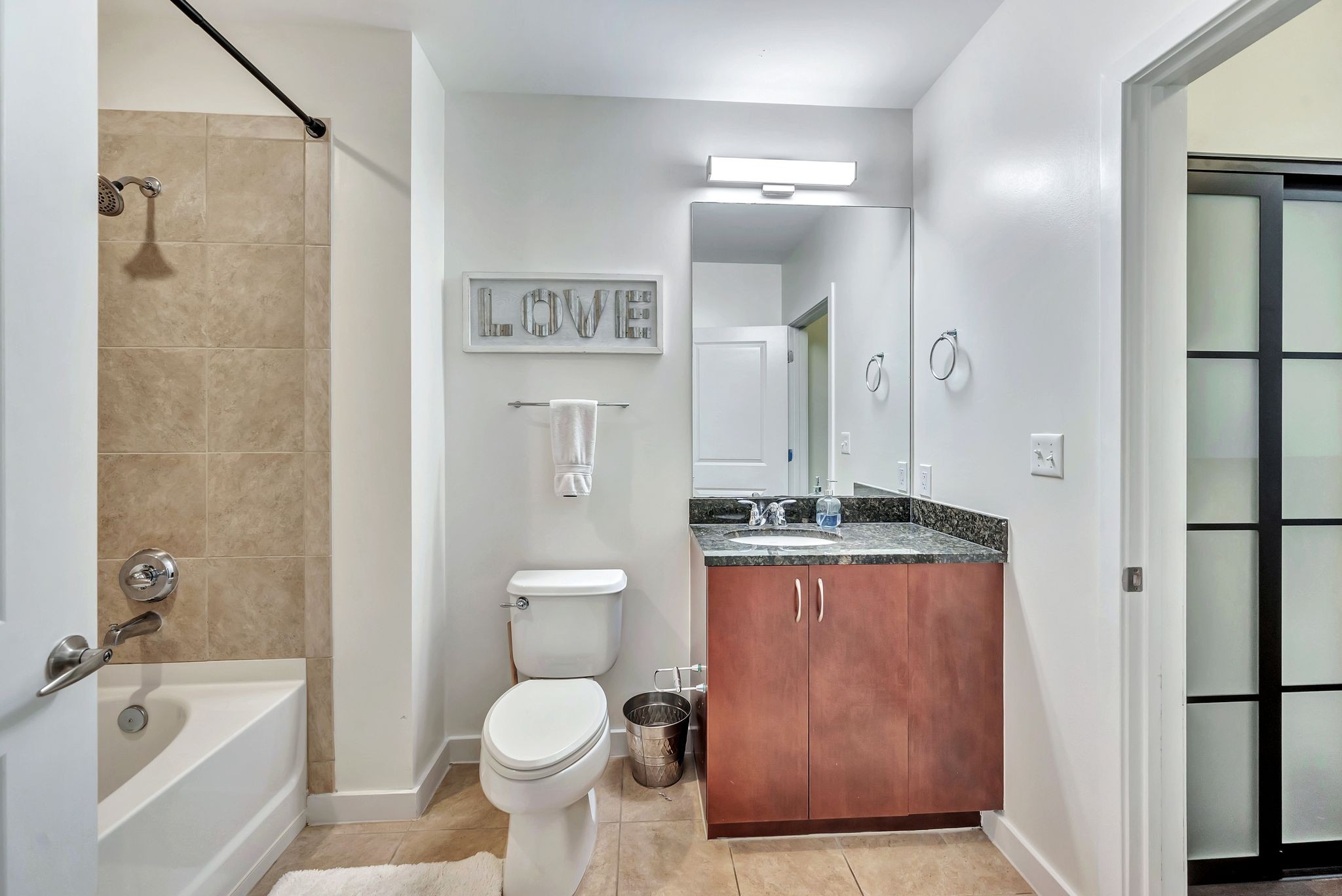 301 Demonbreun Street, Unit 1120 Nashville, TN 37201 - Photo 29 of 51 a bathroom with a granite countertop sink toilet and shower