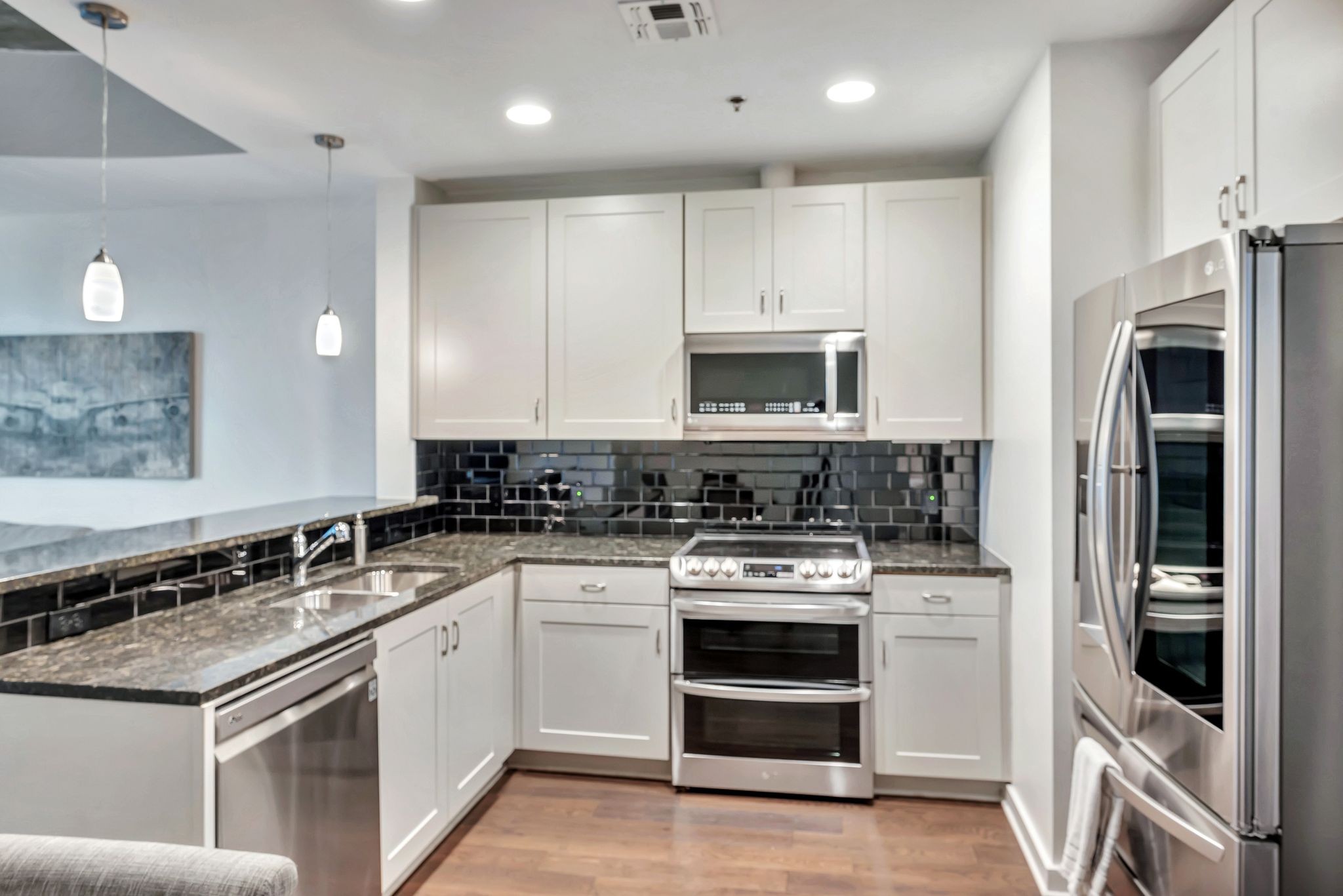 301 Demonbreun Street, Unit 1120 Nashville, TN 37201 - Photo 7 of 51 a kitchen with stainless steel appliances granite countertop a stove and a refrigerator