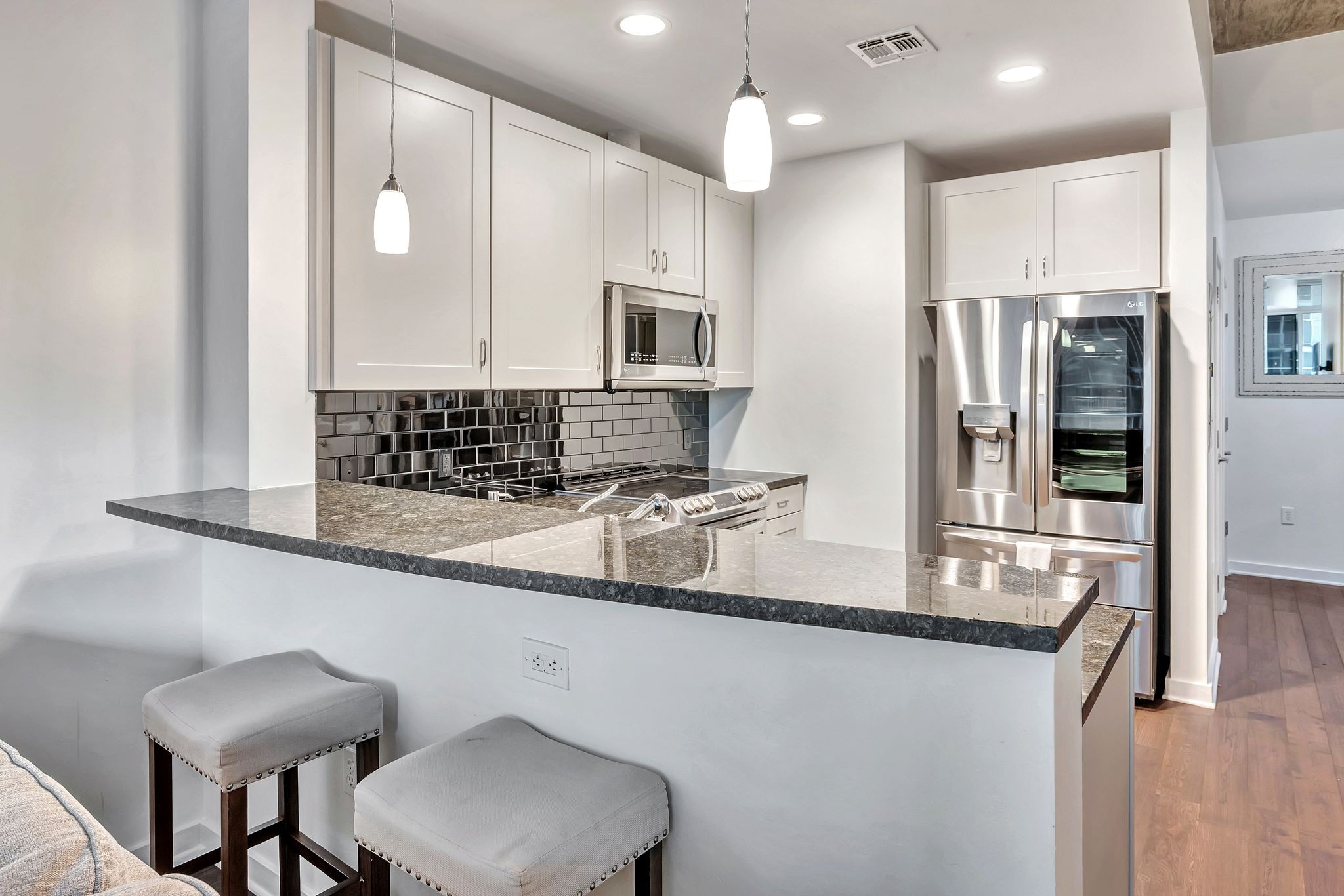 301 Demonbreun Street, Unit 1120 Nashville, TN 37201 - Photo 9 of 51 a kitchen with stainless steel appliances granite countertop a sink refrigerator and cabinets