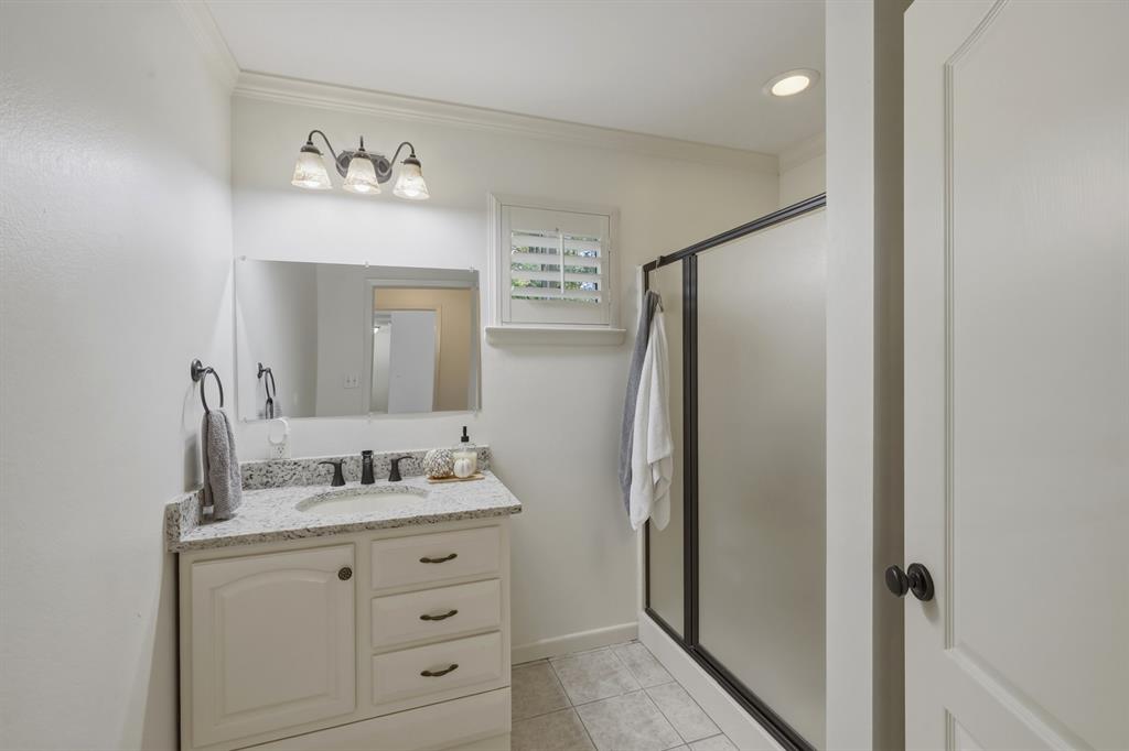 353 Deer Creek Road Big Sandy, TX 75755 - Photo 19 of 25 a bathroom with a granite countertop sink and a mirror