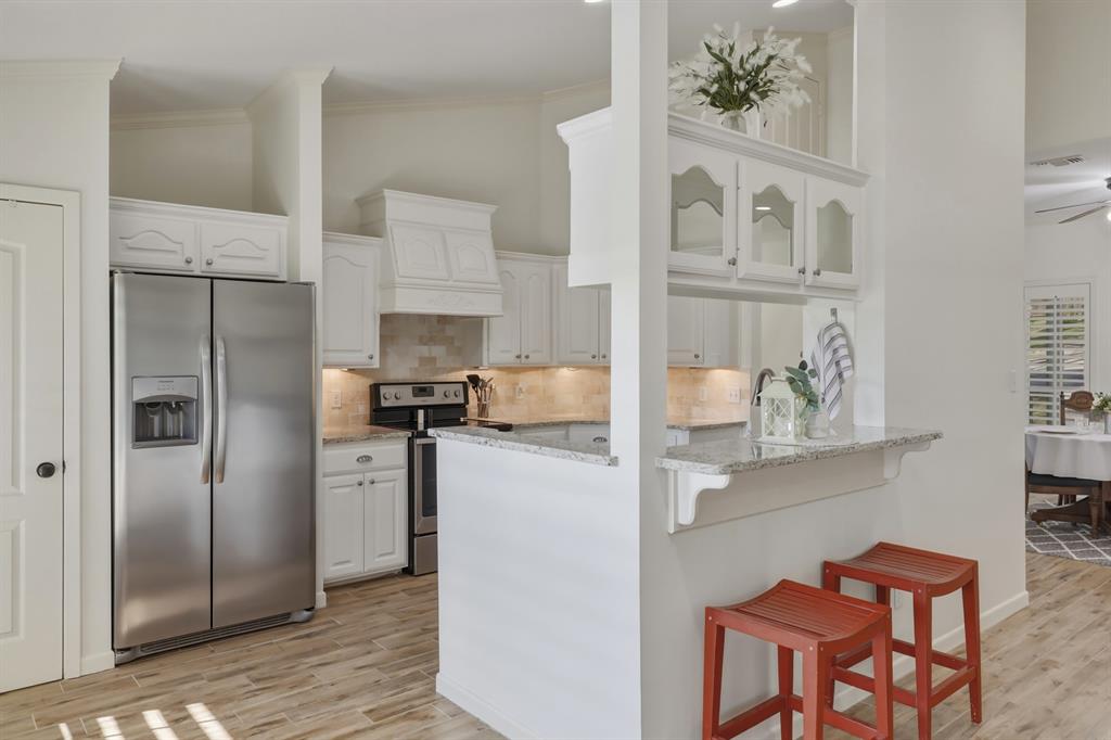 353 Deer Creek Road Big Sandy, TX 75755 - Photo 5 of 25 a kitchen with stainless steel appliances granite countertop a refrigerator and a stove top oven