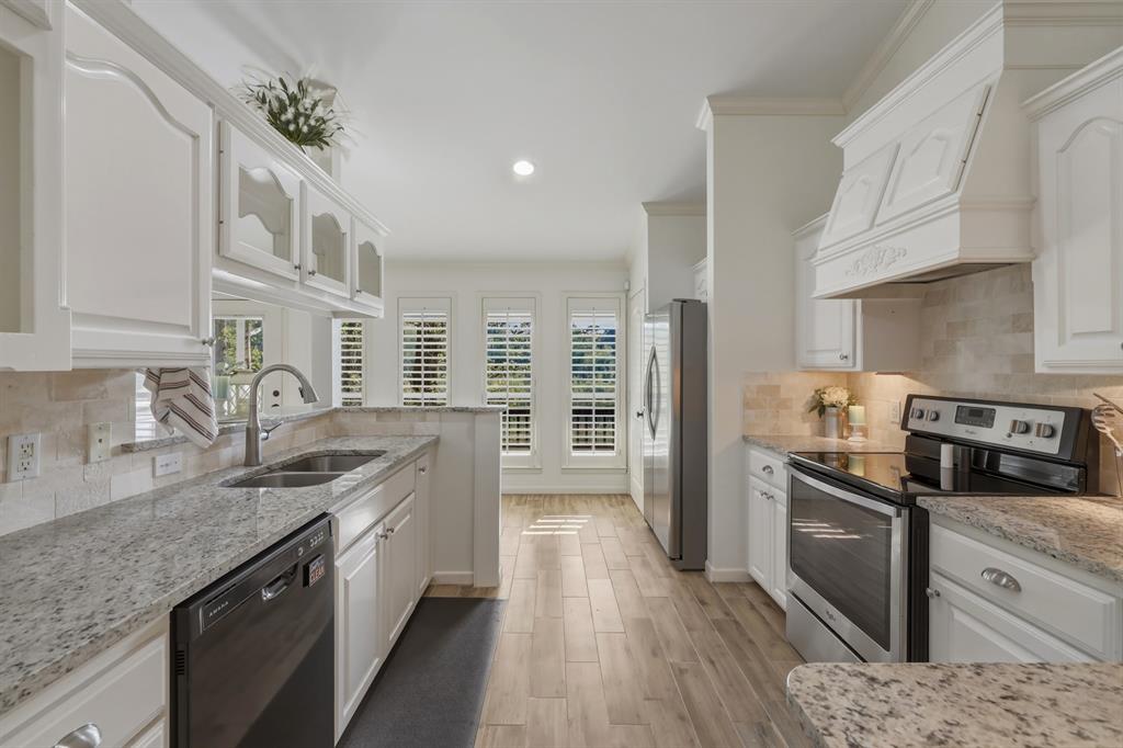 353 Deer Creek Road Big Sandy, TX 75755 - Photo 6 of 25 a kitchen with stainless steel appliances granite countertop a sink a stove and a refrigerator