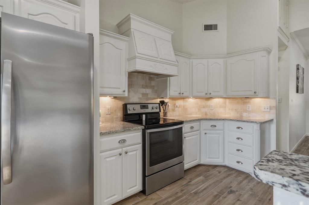 353 Deer Creek Road Big Sandy, TX 75755 - Photo 8 of 25 a kitchen with granite countertop white cabinets and stainless steel appliances