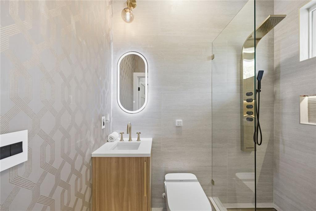 1253 Brooklawn Road Northeast Brookhaven, GA 30319 - Photo 25 of 55 a bathroom with a sink a toilet and a mirror