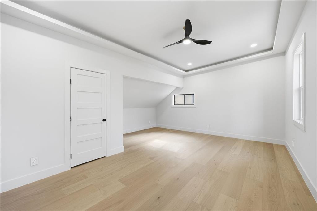 1253 Brooklawn Road Northeast Brookhaven, GA 30319 - Photo 26 of 55 an empty room with wooden floor ceiling fan and window