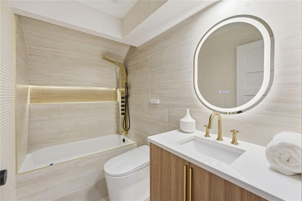 1253 Brooklawn Road Northeast Brookhaven, GA 30319 - Photo 29 of 55 a bathroom with a sink a toilet and a mirror