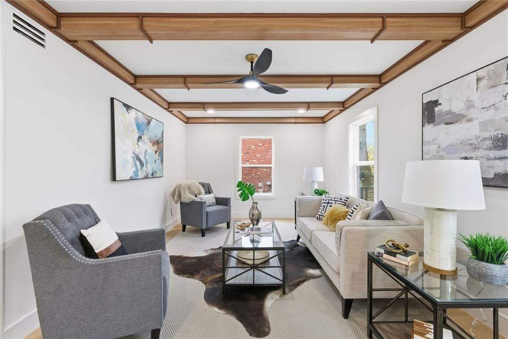 1253 Brooklawn Road Northeast Brookhaven, GA 30319 - Photo 6 of 55 a living room with furniture and a chandelier