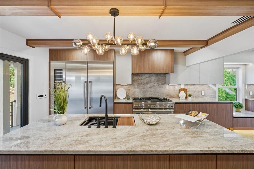 1253 Brooklawn Road Northeast Brookhaven, GA 30319 - Photo 7 of 55 a kitchen with a granite counter top a stove and a chandelier