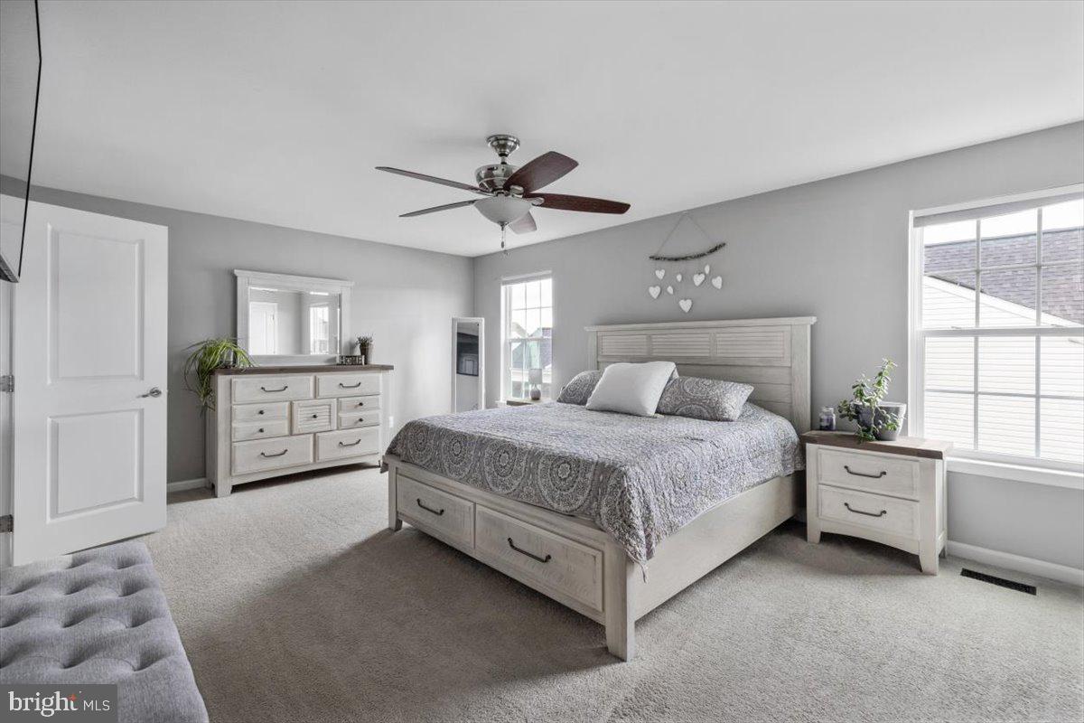 217 Morlyn Drive Stephenson, VA 22656 - Photo 15 of 35 a spacious bedroom with a bed a window and a chandelier
