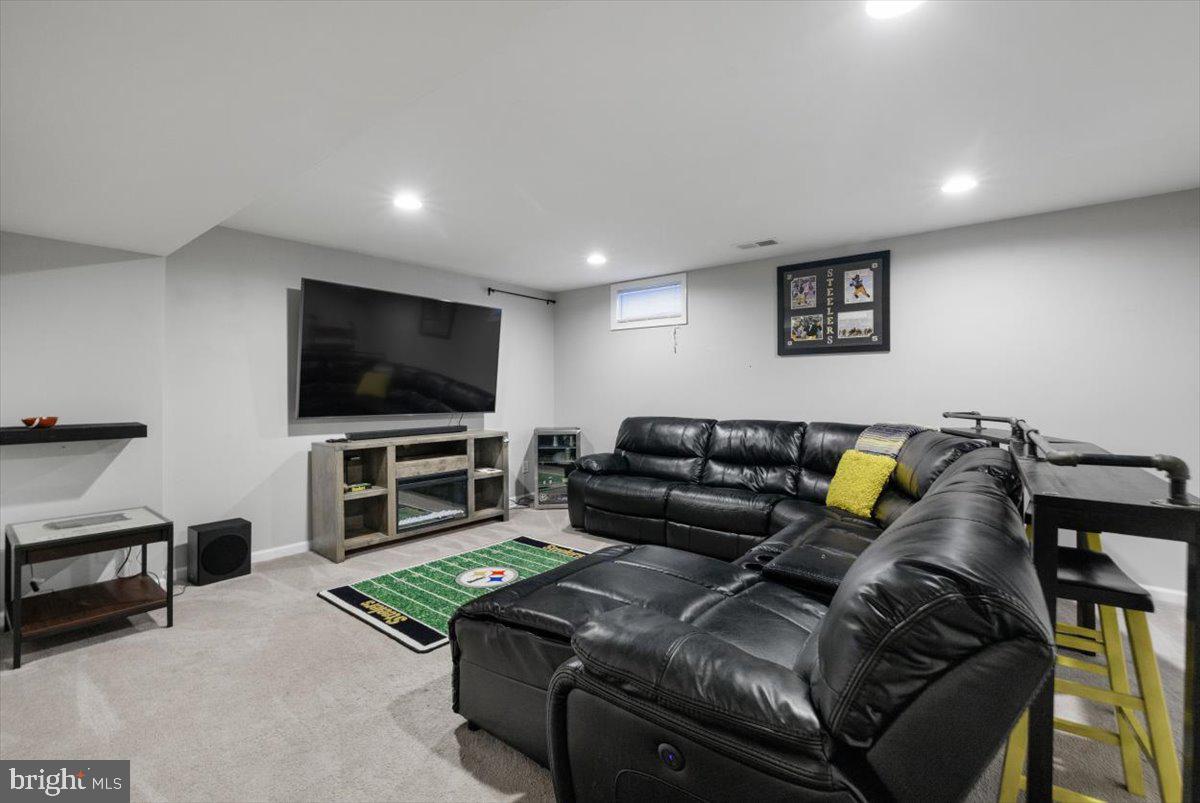 217 Morlyn Drive Stephenson, VA 22656 - Photo 24 of 35 a living room with furniture and a flat screen tv