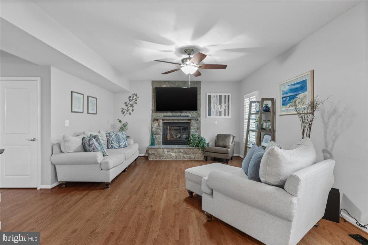 217 Morlyn Drive Stephenson, VA 22656 - Photo 6 of 35 a living room with furniture a fireplace and a flat screen tv