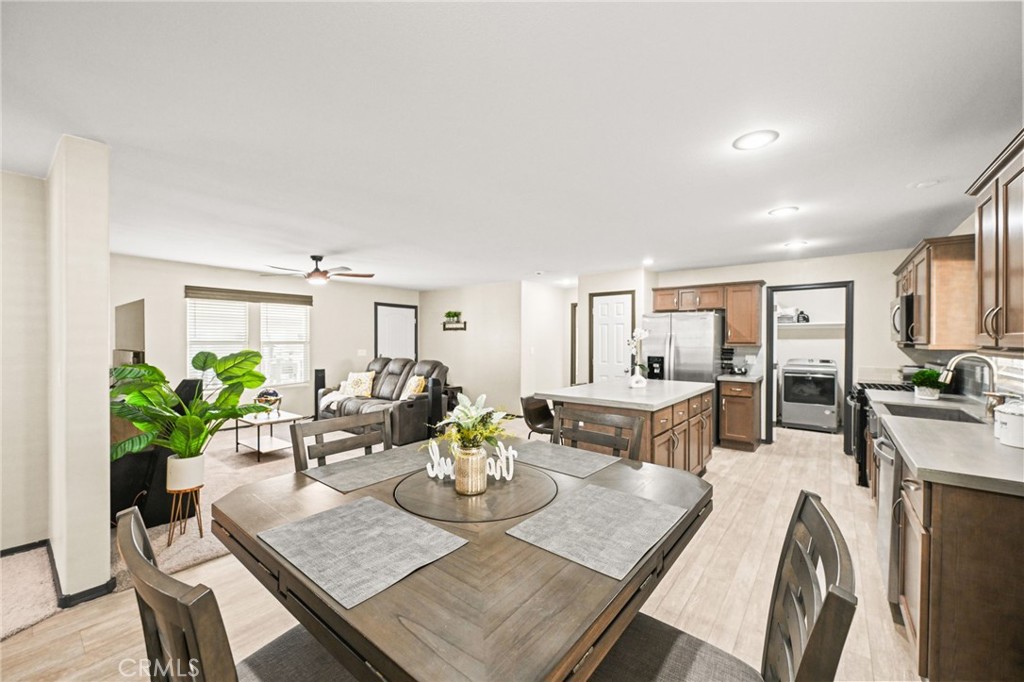 16860 Slover Avenue, Unit 70 Fontana, CA 92337 - Photo 16 of 38 a view of a dining room with furniture a potted plant and wooden floor