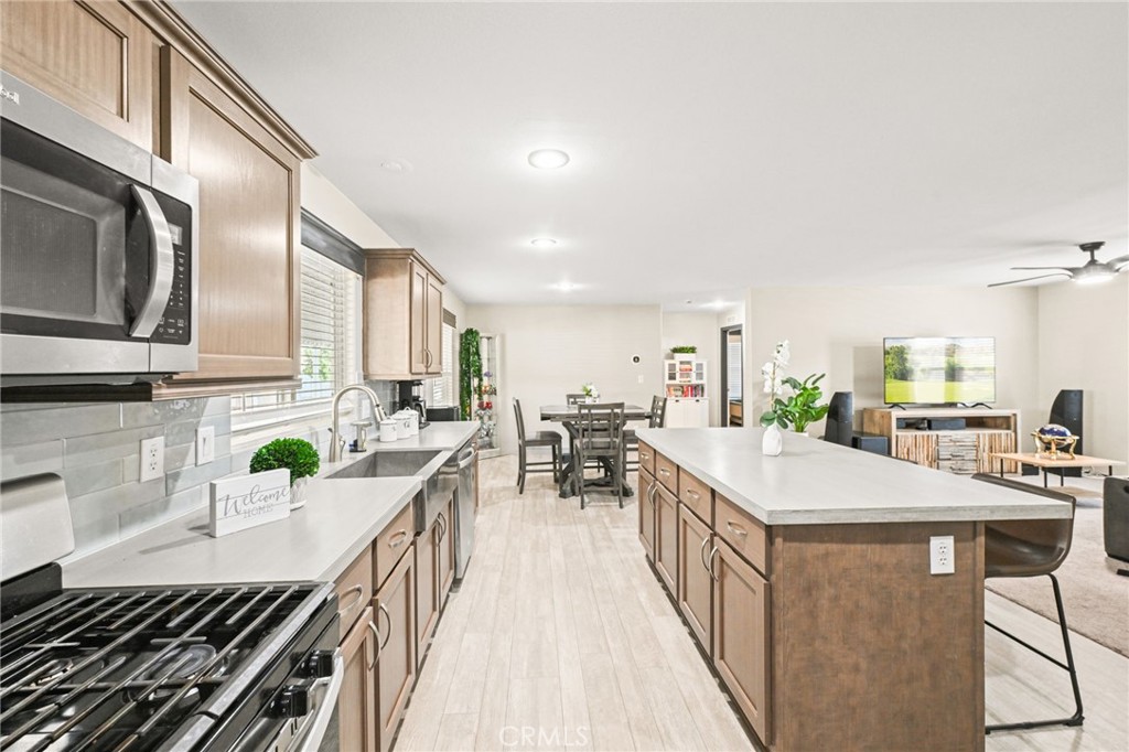 16860 Slover Avenue, Unit 70 Fontana, CA 92337 - Photo 17 of 38 a kitchen with counter top space a sink appliances and cabinets