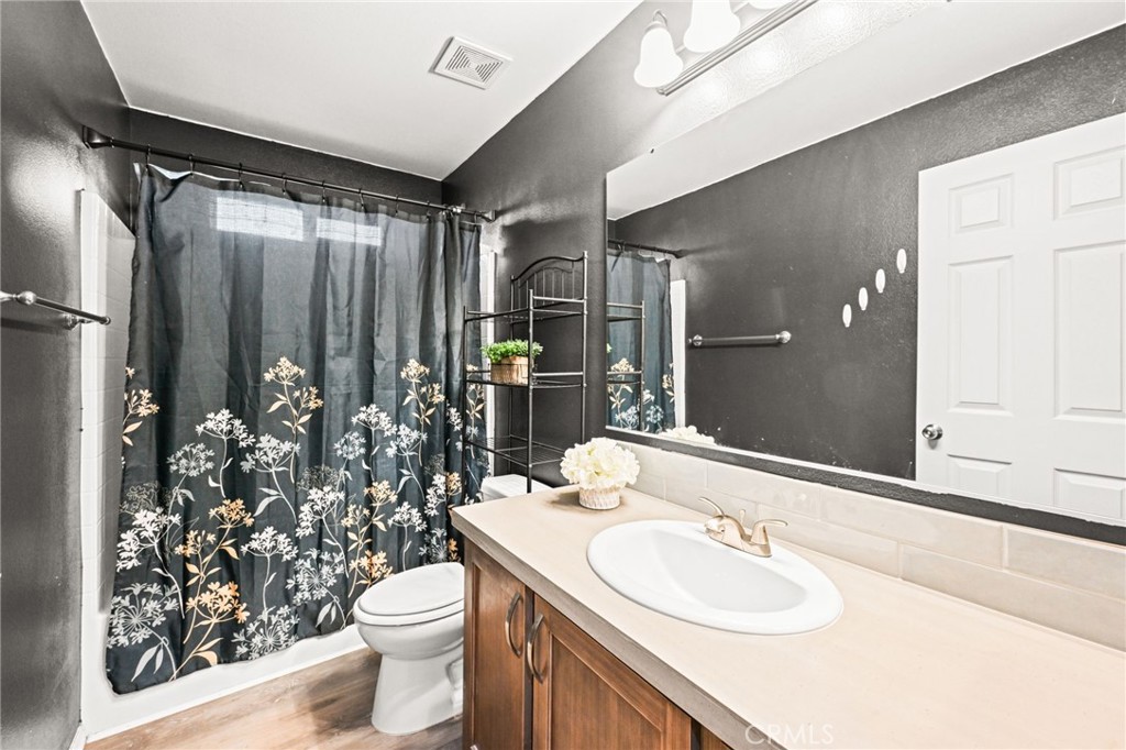 16860 Slover Avenue, Unit 70 Fontana, CA 92337 - Photo 22 of 38 a bathroom with a sink toilet and shower