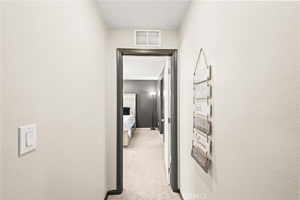 16860 Slover Avenue, Unit 70 Fontana, CA 92337 - Photo 30 of 38 a view of a hallway with wooden floor