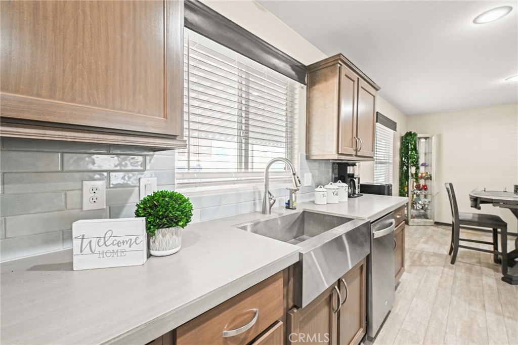 16860 Slover Avenue, Unit 70 Fontana, CA 92337 - Photo 9 of 38 a kitchen with a sink and cabinets